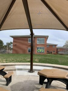 The new Outdoor Classroom at Schwenksville Elementary with an umbrella covering the picnic tables.
