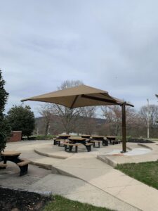 The new Outdoor Classroom at Schwenksville Elementary with an umbrella covering the picnic tables.