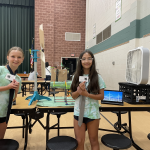 Students showing off their model of wind-power giving energy to Evergreen Elementary.