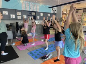 IMG_7964 Mrs. Long and class perform a tree pose